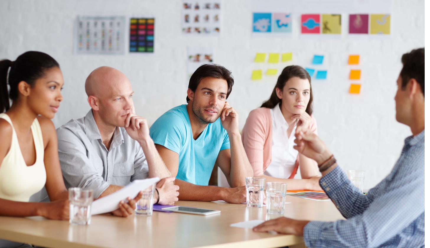 Diverse professionals engaged in a collaborative workplace meeting